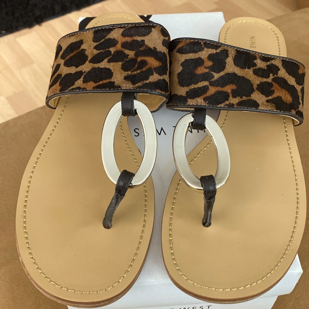Flat leopard print thong sandals with o ring detail.